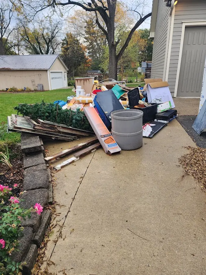 Dumpster being loaded with debris for 12 Yard Dumpster Rental in Haleyville